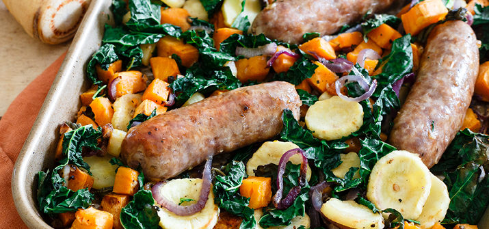 a photo of italian sausage with fall vegetables in a casserole dish