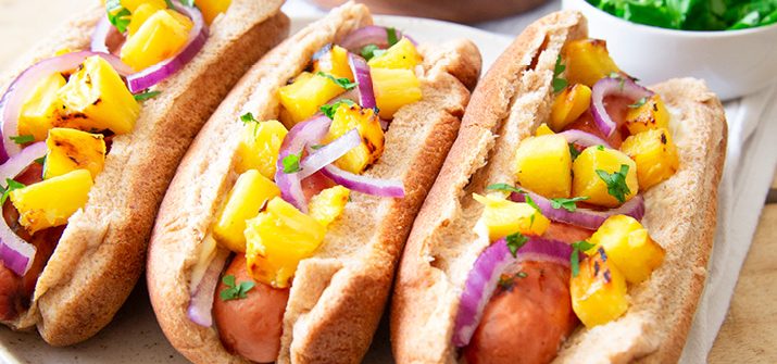 a photo of Hawaiian Hot Dogs topped with pineapple