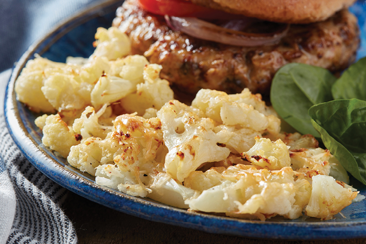Tender, sweet cauliflower is smashed and baked to form a crispy crust of parmesan cheese. 