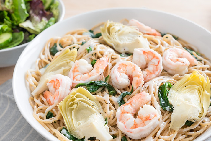 Keep it simple and satisfying with this whole wheat pasta dish featuring shrimp, spinach and artichoke hearts.