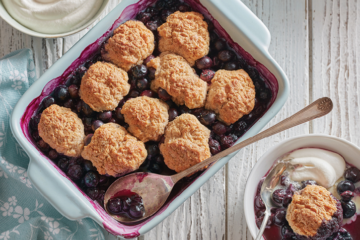 Everybody loves blueberries, especially when they are bubbling under a blanket of tender, sweet biscuits.